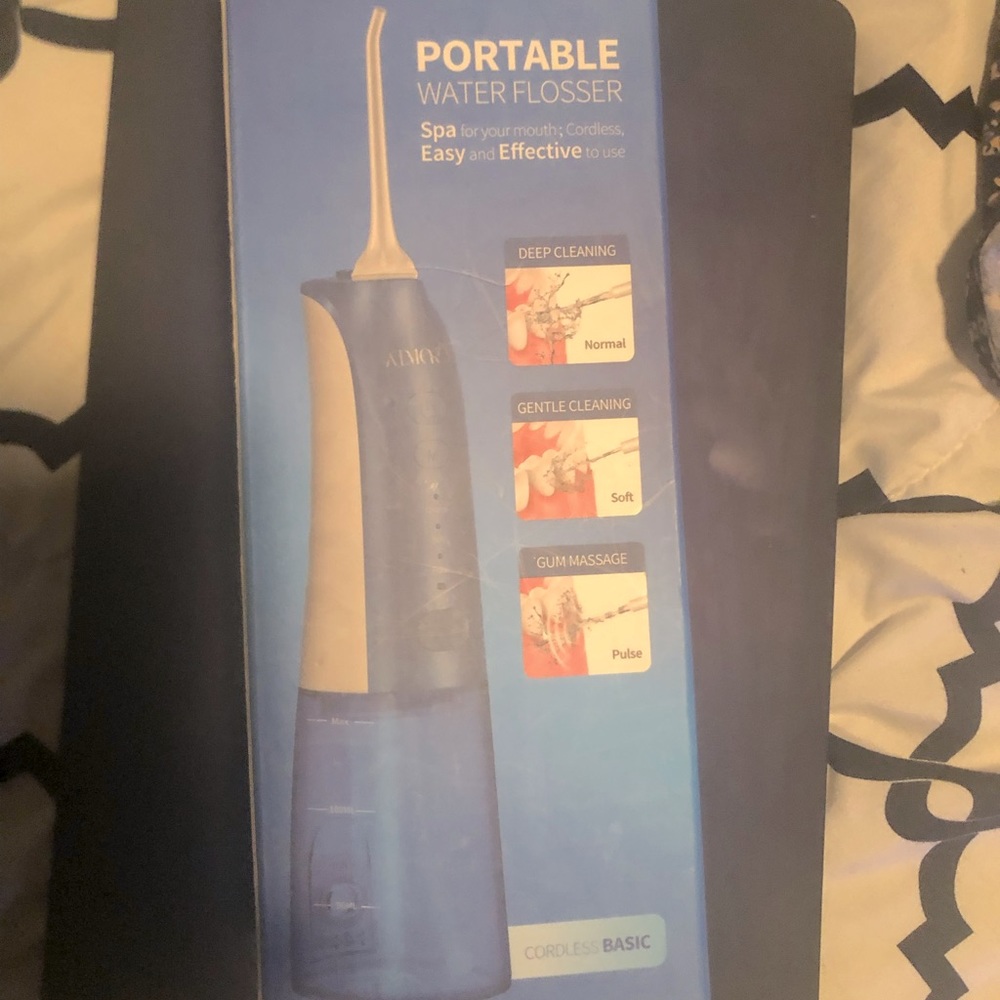 Portable water flosser. Never used or opened from Amazon